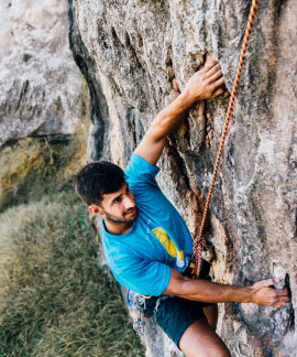 Cozy library reading corner with wooden bookshelves and plush armchairs at Ojaswi Resort.