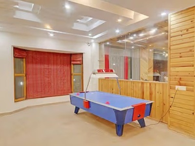 Elegant interior of the Deluxe Room at Ojaswi Resort Mukteshwar, featuring premium bedding and modern decor. 