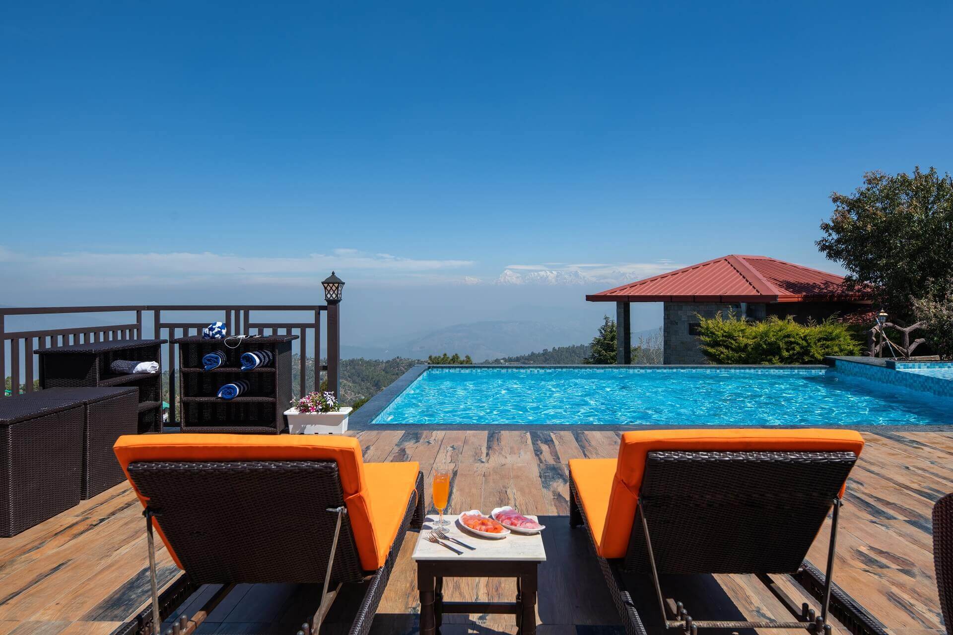 Luxury infinity pool at Ojaswi Resort Mukteshwar, featuring breathtaking panoramic views of the Himalayan peaks.