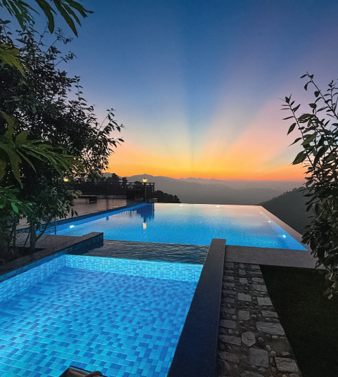 Infinity pool at Ojaswi Resort in Mukteshwar overlooking Himalayan ridges during a serene sunset tea experience