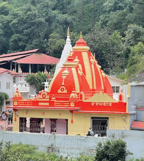 Sacred temple near Ojaswi Resort in Mukteshwar surrounded by lush green Himalayan forests, showcasing local culture and spiritual heritage