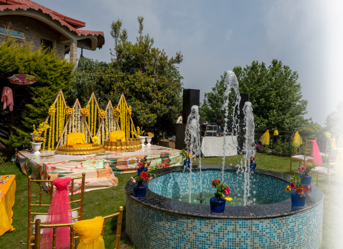 Vibrant Haldi ceremony setup at Ojaswi Resort with traditional yellow decor and a scenic Himalayan backdrop.